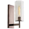 A stunning architectural design, this sconce is modern in every way. A hexagonal clear glass shade delivers an edge to its linear design that is softened by the brown nickel finish of its steel frame.