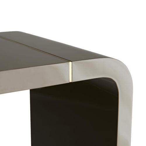 Clean and curvaceous lines define this console's sleek profile. A rich gray lacquer finish brings a luxe shine to the wood frame, while the thin antique brass inlays that lie near the edges elevate its overall sleekness.