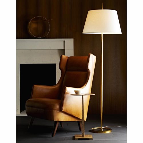warm tones and antique brass. This elegant leather accent chair pairs with the hand-etched brass table.