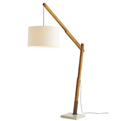 The industrial inspired, fixed-angle natural teak arm is mounted into a cream concrete base. Running along itslength is a gray cloth cord that suspends the lamp at different heights—the extra length can be wrapped around the mounted anchor on the side. The lamp is fitted with an ivory linen drum shade with ivory cotton lining and a dimmer switch.