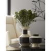 Elegant black and white porcelain vases adds visual appeal and texture to a soft palette room. Vases are finished in crackled ivory with a gunmetal finish.