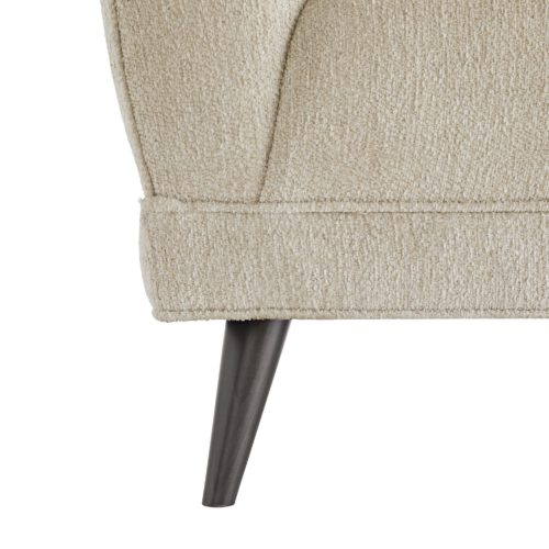 It is designed in a modern way, but softened with rolling curves, rounded angles and an extra plush seat. Up close, observe all the immaculate details, likecorner pleating, self welting and grey ash finished tapered legs. Upholstered with a textural boucle in a soft shade of pale gray, this hue complements a palette of almost any range.