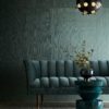 Ultra chic mid-century living room in deep jewel tones. Elegant velvet sofa with dark walnut and gold accents.