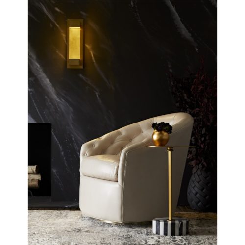 Elegant tufted leather accent chair. Chair swivels and finished in champagne.