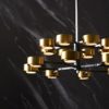 Bronze and brass combine to create this large-scale, modern 16-light chandelier, Eight horizontal rods, four on each tier, split into two to give way to contrasting antique brass shades and frosted glass diffusers. Perfect over a large dining table or as the focal point above an island in a grand kitchen.