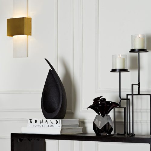 Elegant and chic modern living room decor. Abstract charcoal sculpture accented with natural iron torchiere's.