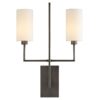 Reach out your arms and grab the glory, this sconce stretches wide with two steel dowels supporting cylindrical white linen shades. The dowels are supported off an elegant central steel blade. The scale of this fixtureprovides architectural interest while amplifying the light in any entry hall, corridor or room. Finished in aged bronze.