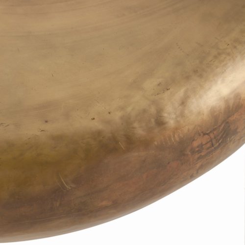 This voluminous drum cocktail table is made of iron then finished in burnt brass, a golden finish a bit lighter than antique brass. We love the artisan look and feel.