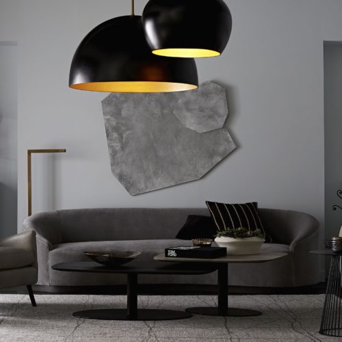 Black matte pendants in different sizes anchor this room. The deep black finish adds drama while the gold pops. Gray tones add warmth with the elegant velvet sofa.
