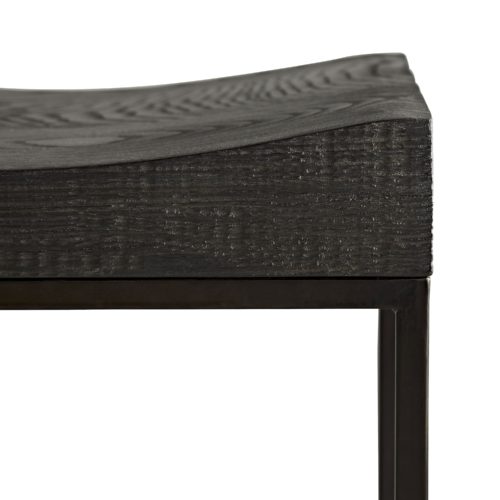 Solid oak is carved by hand to form the contoured seat of this handsome bench. The ebony-finished wood rests on a natural iron frame, delivering a refined element to its textured form.Its minimalist profile and industrial characteristics make this a fitting option for modern spaces.