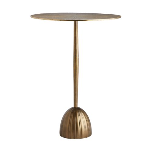 Crafted completely from cast aluminum, its circular top features a rhythmic design that delivers immense texture.A slender frame slightly tapers into a ribbed, bell-shaped base—adding a functional element that serves style and stability. A vintage brass finish elevates its classic characteristics.