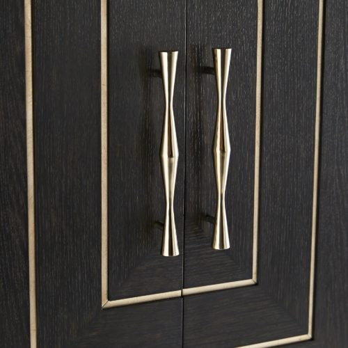 tyle and elegance come together in this entertaining cabinet. Built from solid oak, it’s finished entirely in a dark sable veneer with shining accents of champagne brass handles and foiled-glass inlay details.