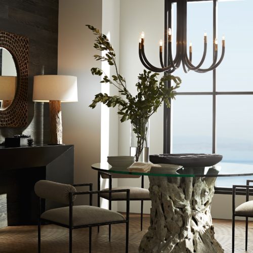 Driftwood Dining table draws you in, while the chandelier adds dimension to this beautiful dining space.