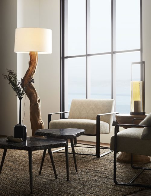 Natural hues make this nature inspired modern living space breath. Chenille lounge chair in ivory paired with the tree trunk floor lamps and industrial style accent tables.