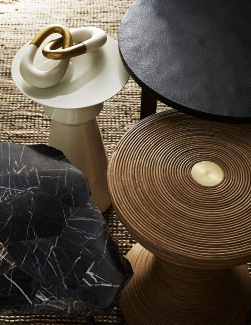 Beautiful natural stone accent tables paired with natural rattan side table that's sultry and curvy with brass inlay.